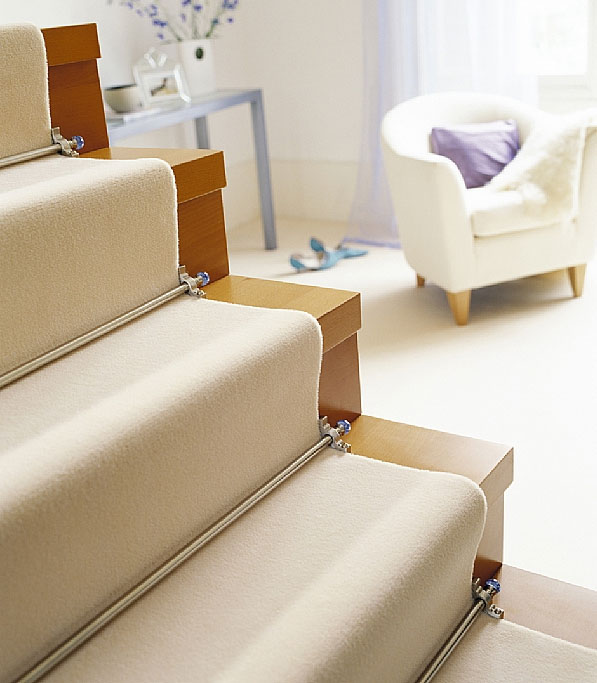 Chrome stair rods with crystal ends on cream carpet runner 